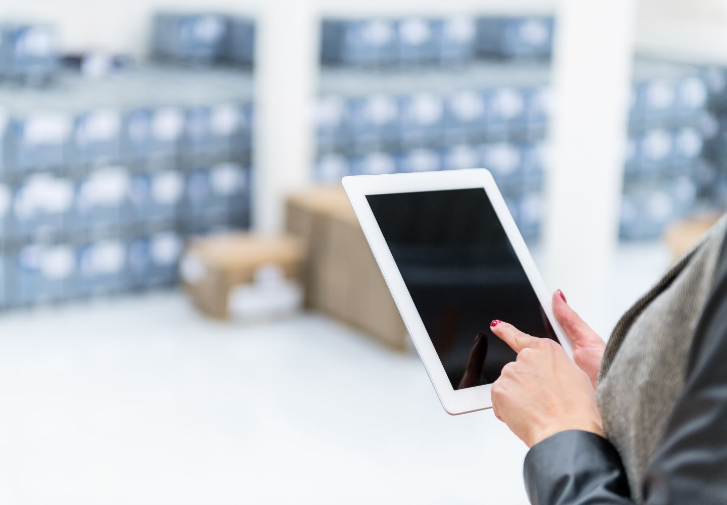 woman pointing to tablet with blue boxes in the background