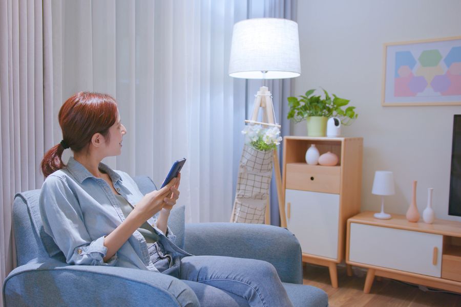 a person sitting in a chair holding a phone